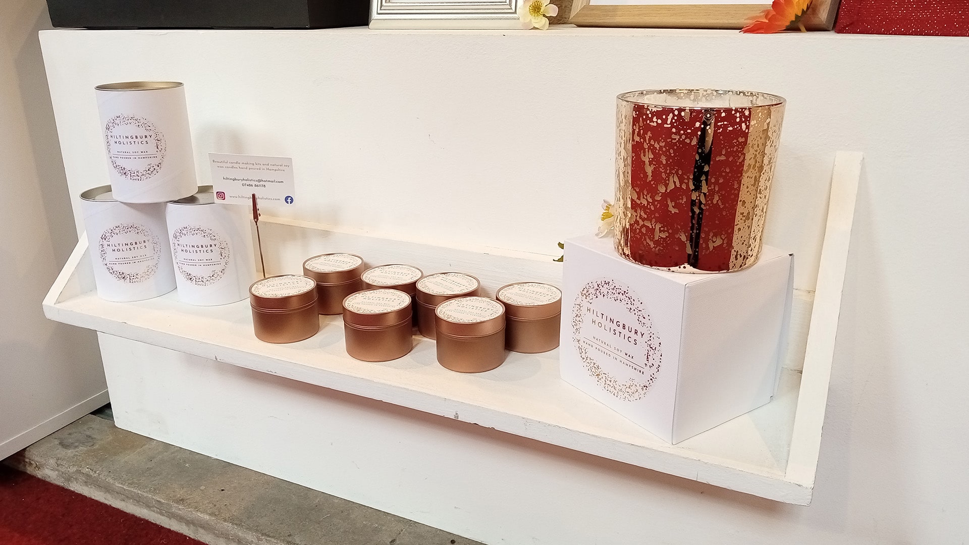 A photograph of golden candles laid out in a decorative way on a shelf.